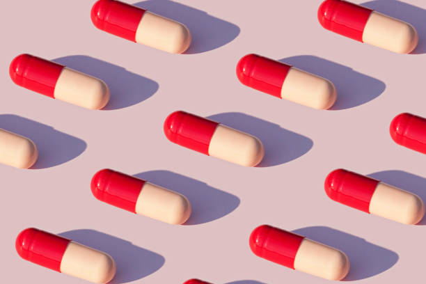 Capsules Capsules pattern on pink background probiotic pattern stock pictures, royalty-free photos & images