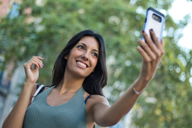 istock Female consumer using a smartphone to take a selfie 1172598095