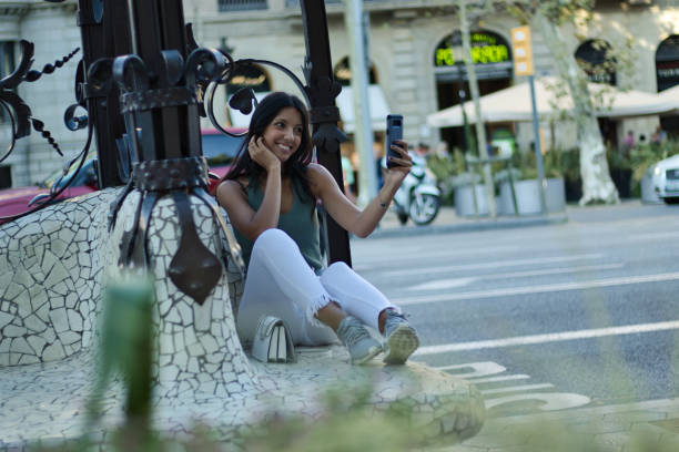 istock Female consumer using a smartphone to take a selfie 1172598104