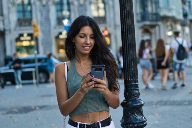 istock Female consumer using a smartphone to listen to music 1172598182