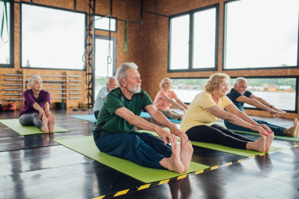 istock Group of seniors stretching during a group yoga class 1172601195