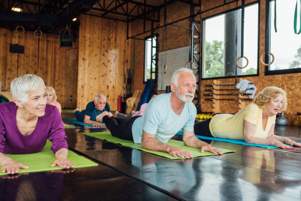 istock Group of seniors doing cobra yoga exercise 1172601247
