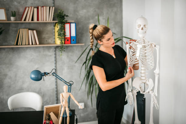 istock Massage Therapist Instructor giving lecture in classroom 1172601279