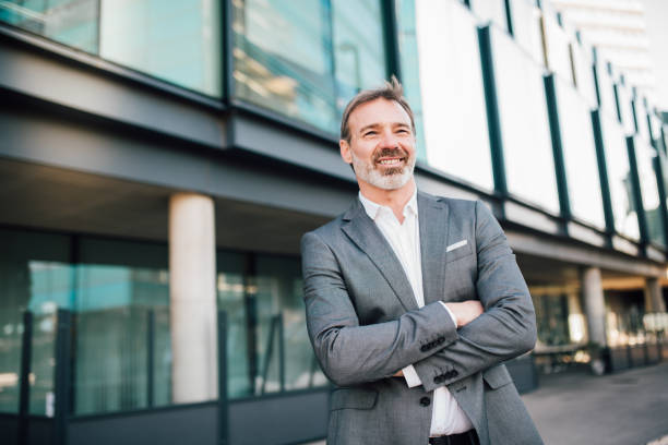 istock Mature man in a suit with crossed arms 1172604245