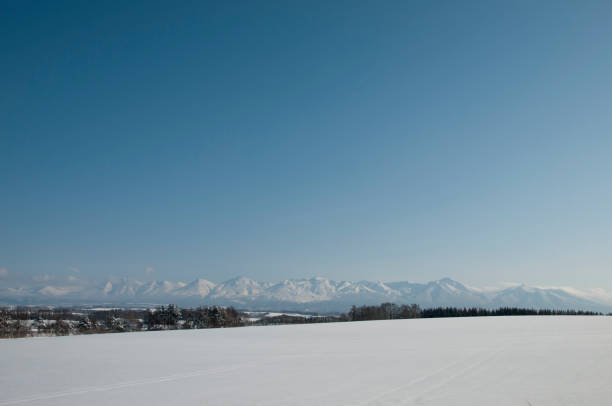 istock Snowy plain and winter mountains,Tokachdake mountain range 1172606611