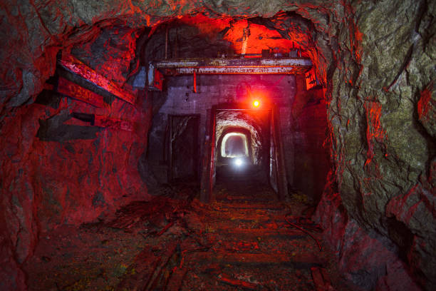 istock Dark dirty abandoned uranium mine with rusty remnants of railway 1172610032