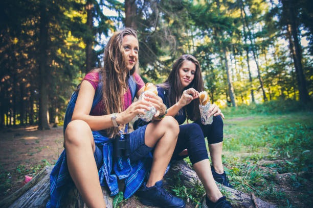 istock Two woman eating sandwich in forest 1172611280