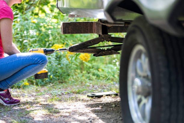 istock Woman Deploying Stabilizer of Camper Trailer on Campground in Summer 1172621558