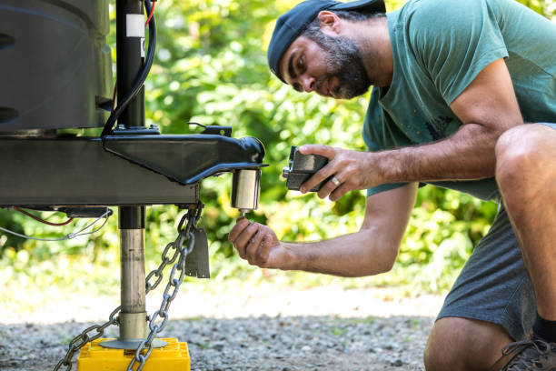 istock Man Installing Camper Trailer Padlock During Camping in Summer 1172621577
