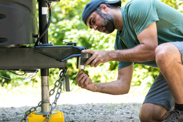 istock Man Installing Camper Trailer Padlock During Camping in Summer 1172622097