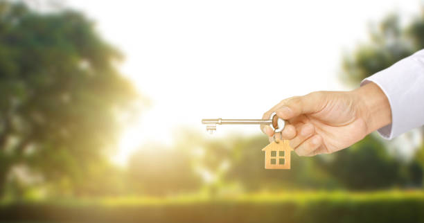 istock Real estate agent handing over house keys 1172624809
