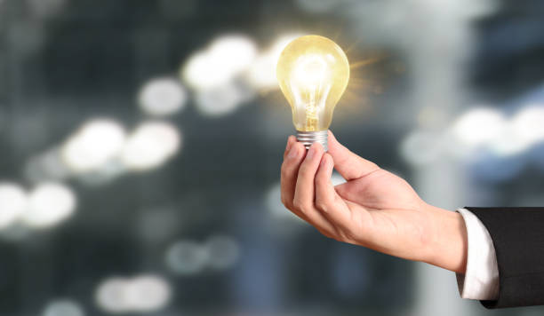 istock Hand of holding illuminated light bulb 1172624819