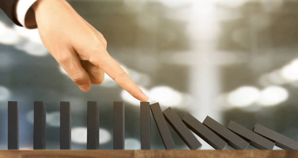 istock Hand stopping  Domino effect stopped by unique 1172624827