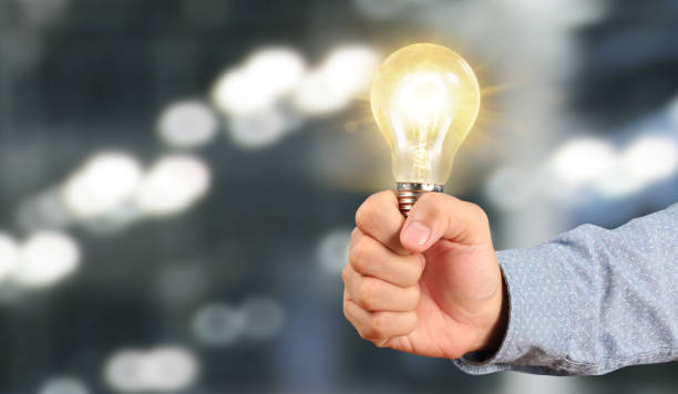 istock Hand of holding illuminated light bulb 1172624841