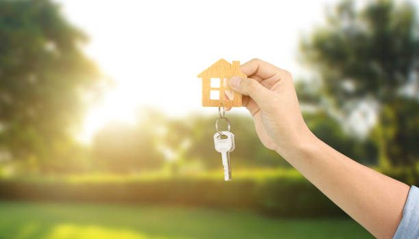istock Real estate agent handing over house keys 1172624933