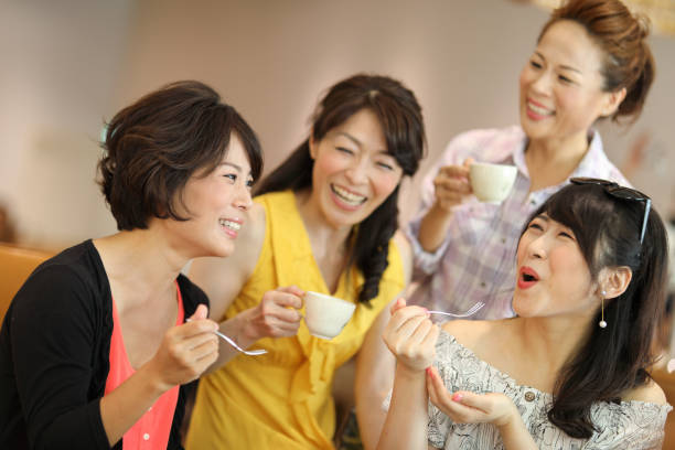 Happy Ladies enjoy eating cake in cafe restaurant