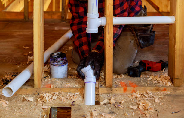 istock Plumber putting glue on a PVC drain pipe, closeup 1172625795