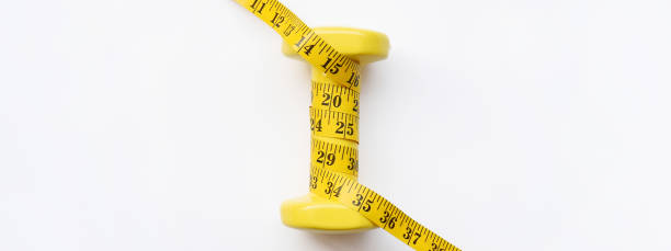 istock Fitness concept dumbbell and measuring tape 1172629189
