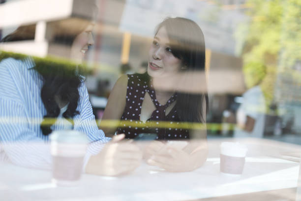istock Female friends talking in cafe 1172629311