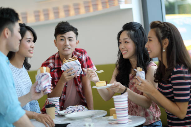 istock young people enjoying dessert in cafe 1172631600