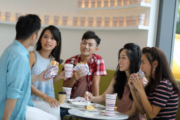 istock young people enjoying dessert in cafe 1172631675