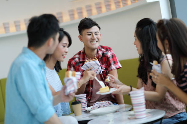 istock young people enjoying dessert in cafe 1172633000