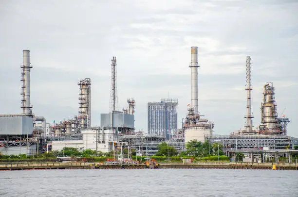 Oil refinery plant of Petrochemistry industry in sunset time, gas and oil production processing in Bangkok, Thailand.