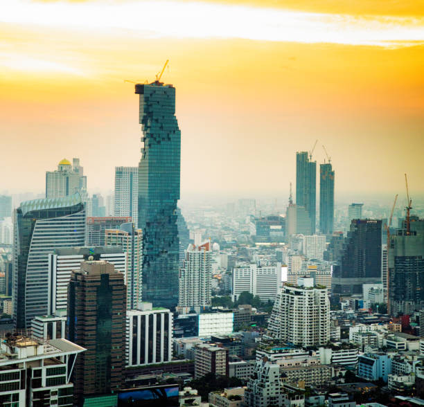 Downtown Bangkok aerial skyline view at sunset with some modern skyscrapers under construction.