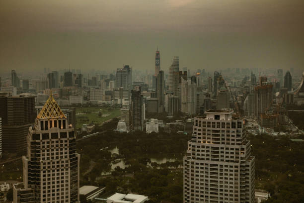 Downtown Bangkok late afternoon covered in thick smog, creating a dark murky atmosphere.