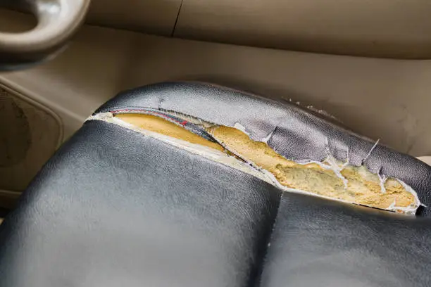 Photo of old synthetic leather car seat damage.