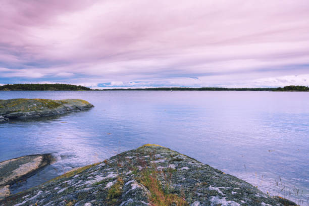 Beautiful rocky on the island summertime in Sweden with colourful twilight sky on the sea