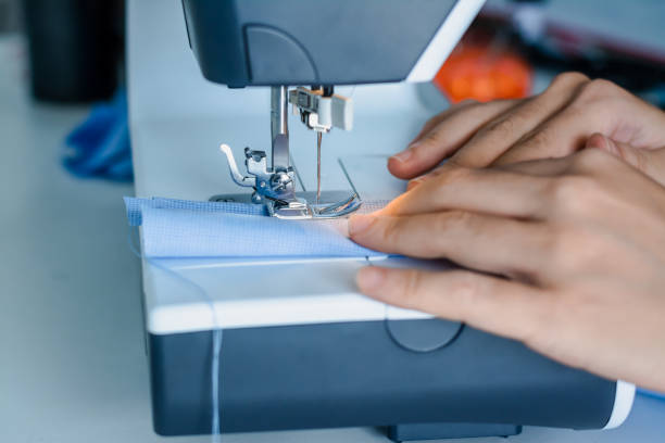 istock Close up dressmaker is process electric sewing machine with fabric and thread ,starting for tailor business. 1172638349