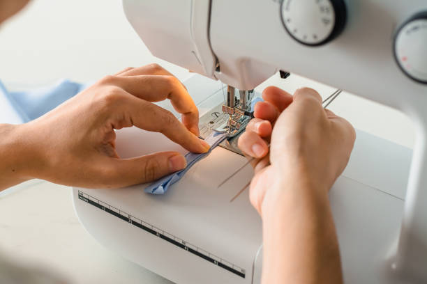 istock Close up dressmaker is process electric sewing machine with fabric and thread ,starting for tailor business. 1172638389