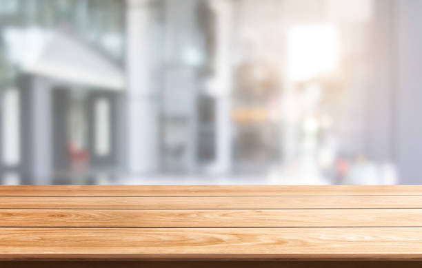 istock Wood table in city center modern office background with empty copy space on the table for product display mockup. Workspace desk interior and place for corporate business. 1172641662