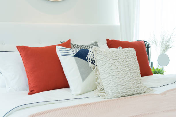 istock White bedroom with white and red pillows on it. 1172642973