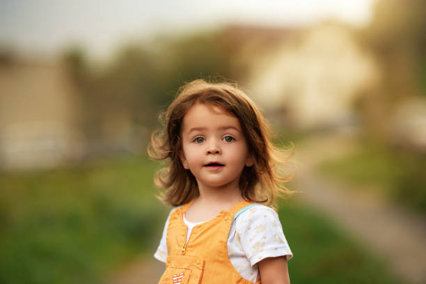 istock Cute girl happily looking at the camera 1172643810
