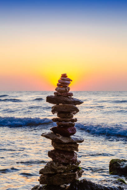 istock Zen Balancing Pebbles. Stack of pebbles on beach with sunrise on background 1172646839