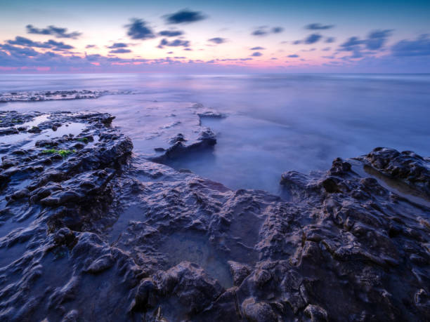 istock Long exposure image of Dramatic sky with rocks in sunset scenery background 1172646840