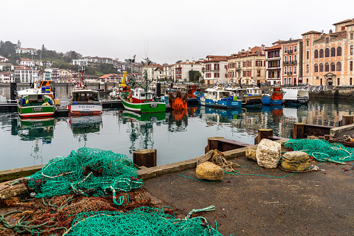 Fishing boats and fishing nets at Saint Jean de Luz harbour. Saint Jean de Luz, France, January 2019