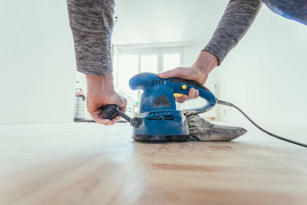 Renovating at home: sander tool for refreshing and grinding the wooden parquet floor stock photo