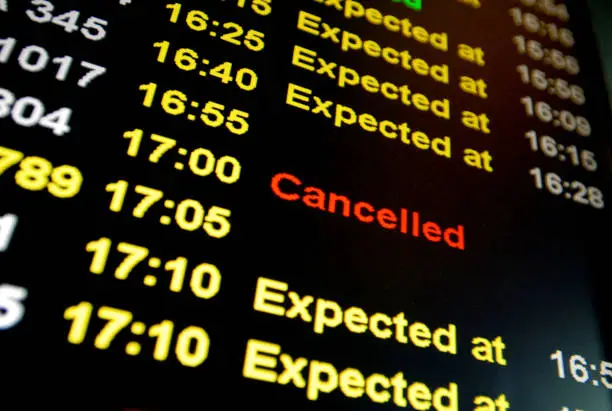 Flight cancelled illuminated on airport arrivals board