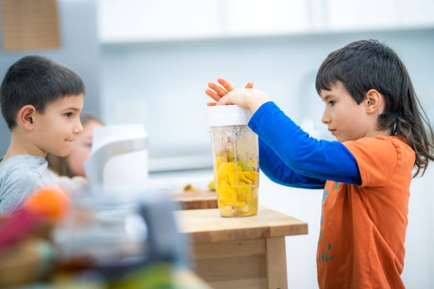 istock Children making smoothie by themselves 1172664378