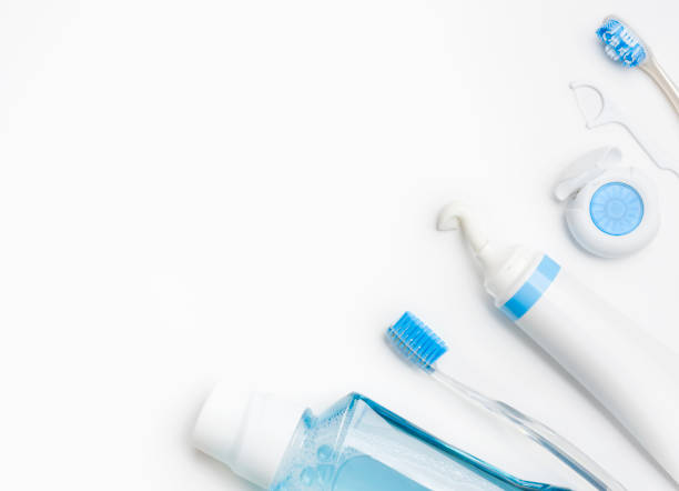 Teeth Brushing Concept with toothbrush, toothpaste, mouthwash and dental floss