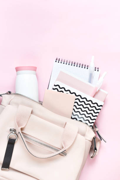 istock Backpack with school supplies and books for study. Back to school concept. Flat lay, top view, pink background 1172671287