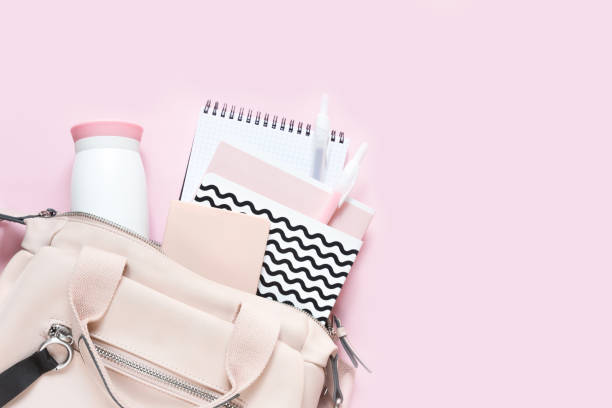 istock Backpack with school supplies and books for study. Back to school concept. Flat lay, top view, pink background 1172671405