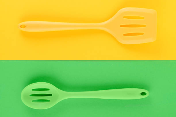 istock bright kitchen utensils on yellow and green background, creative idea 1172674384