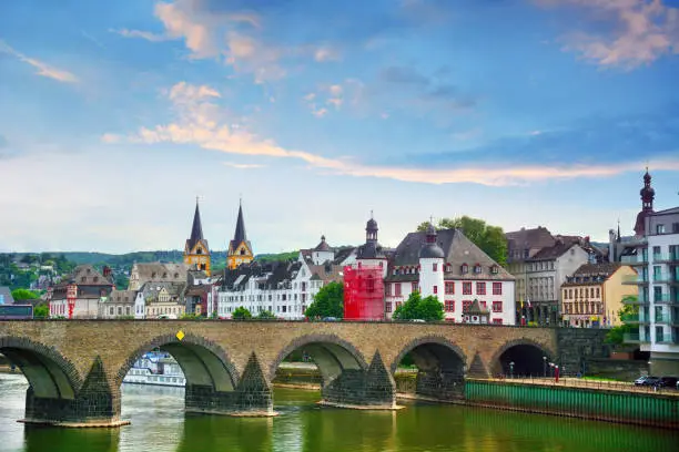The Baldwin Bridge is a old stone arch bridge over the Moselle river at sunset in Koblenz, Germany