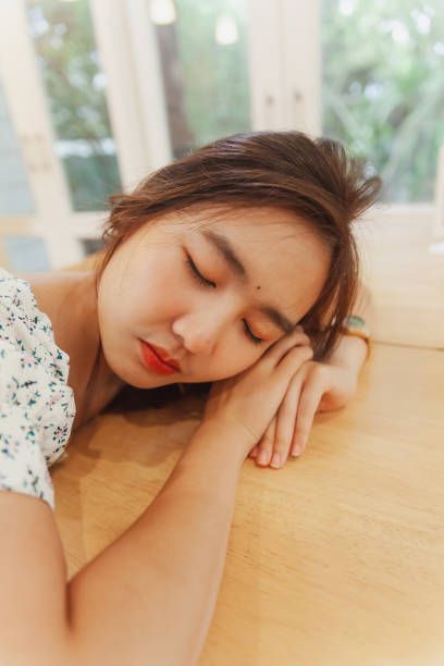 istock Asian women lie on table at dining room. 1172679386