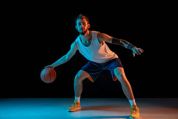 istock Young basketball player against dark background 1172679457