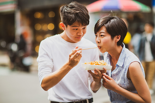 Friends having food on the street